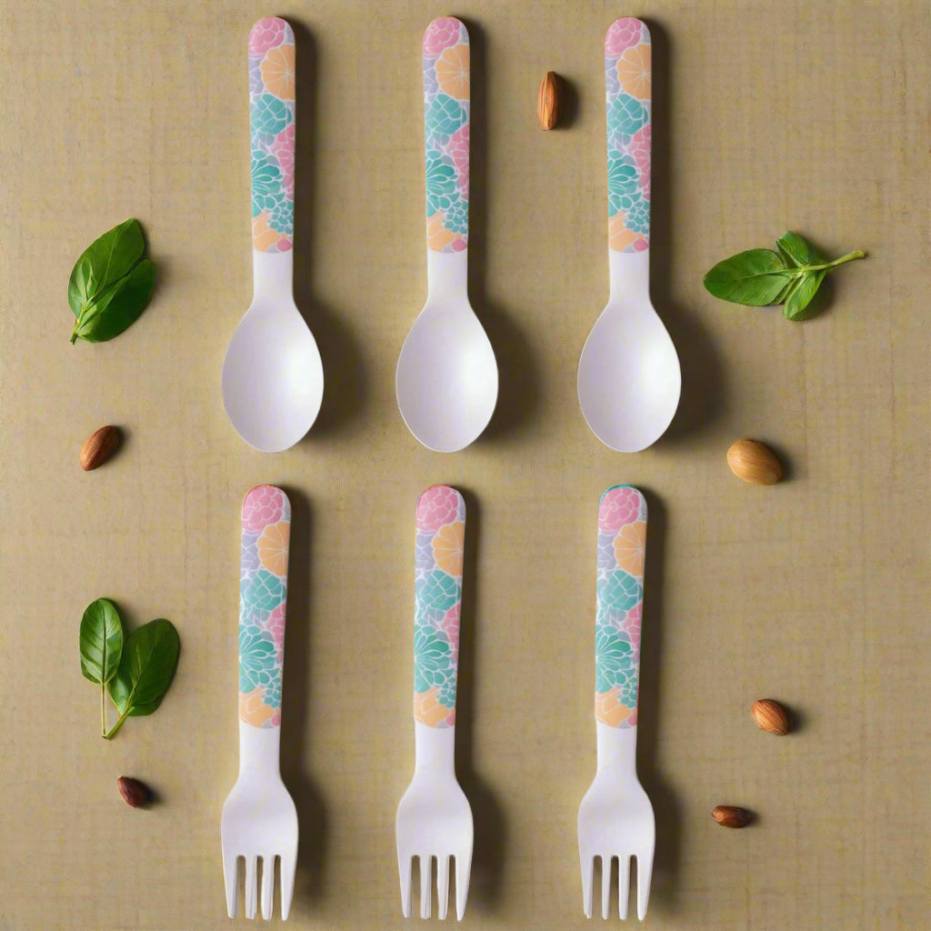 Set of six children's forks and spoons with colorful handle patterns on a white background