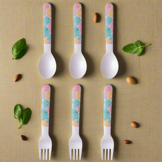 Set of six children's forks and spoons with colorful handle patterns on a white background