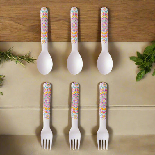 Set of six plastic cutlery with colorful floral patterns on handles against a white background